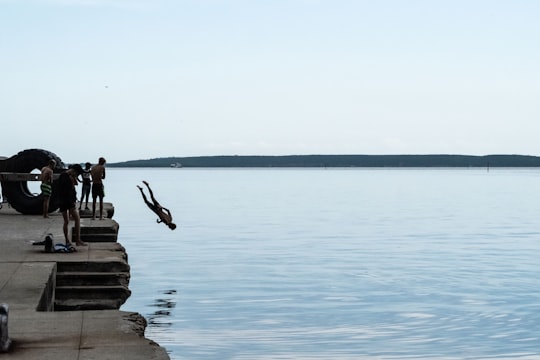 man diving head first from dock in Cienfuegos Cuba