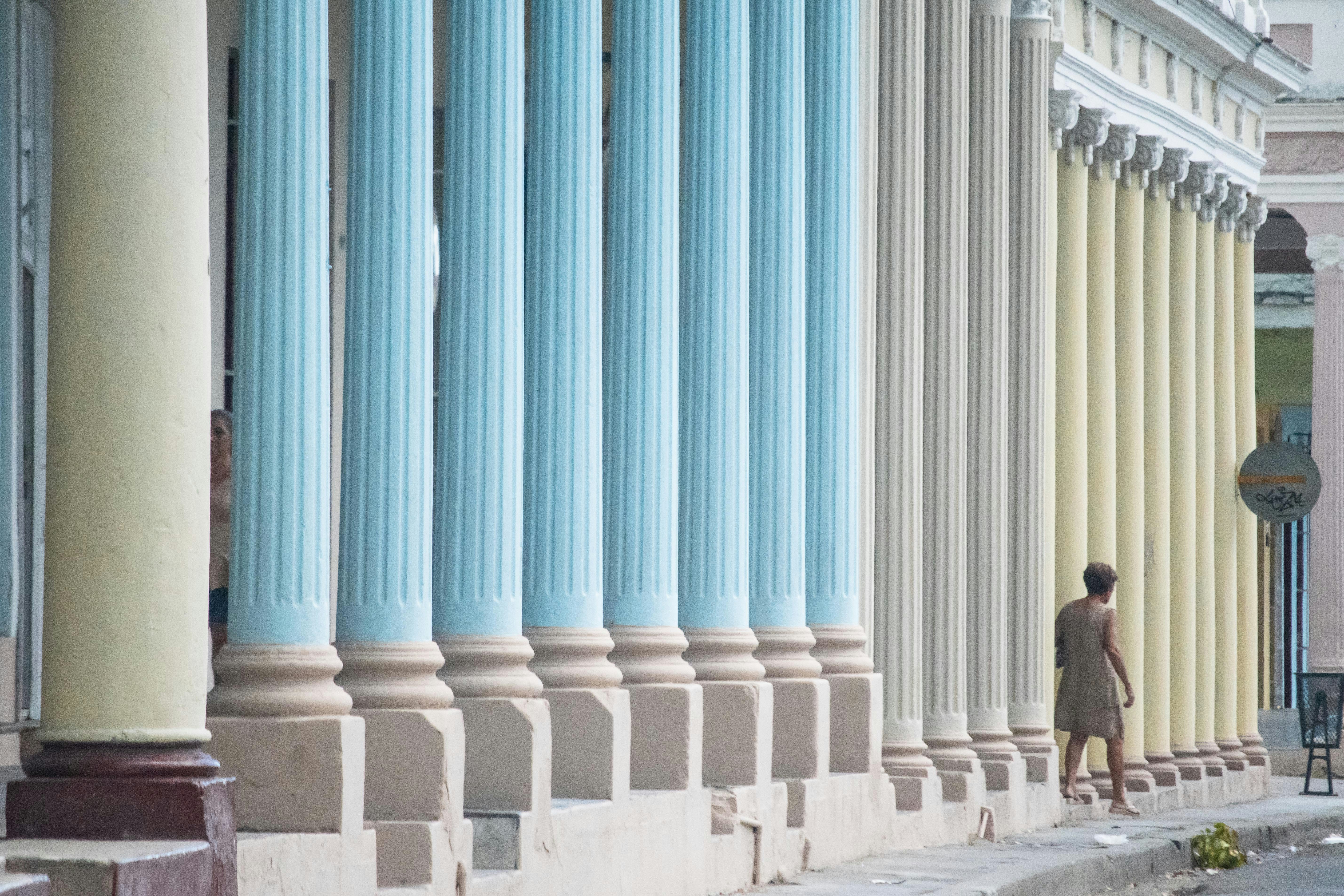 woman standing near building column posts