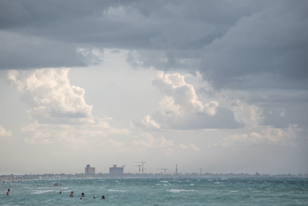 body of water across buildings during cloudy daytime