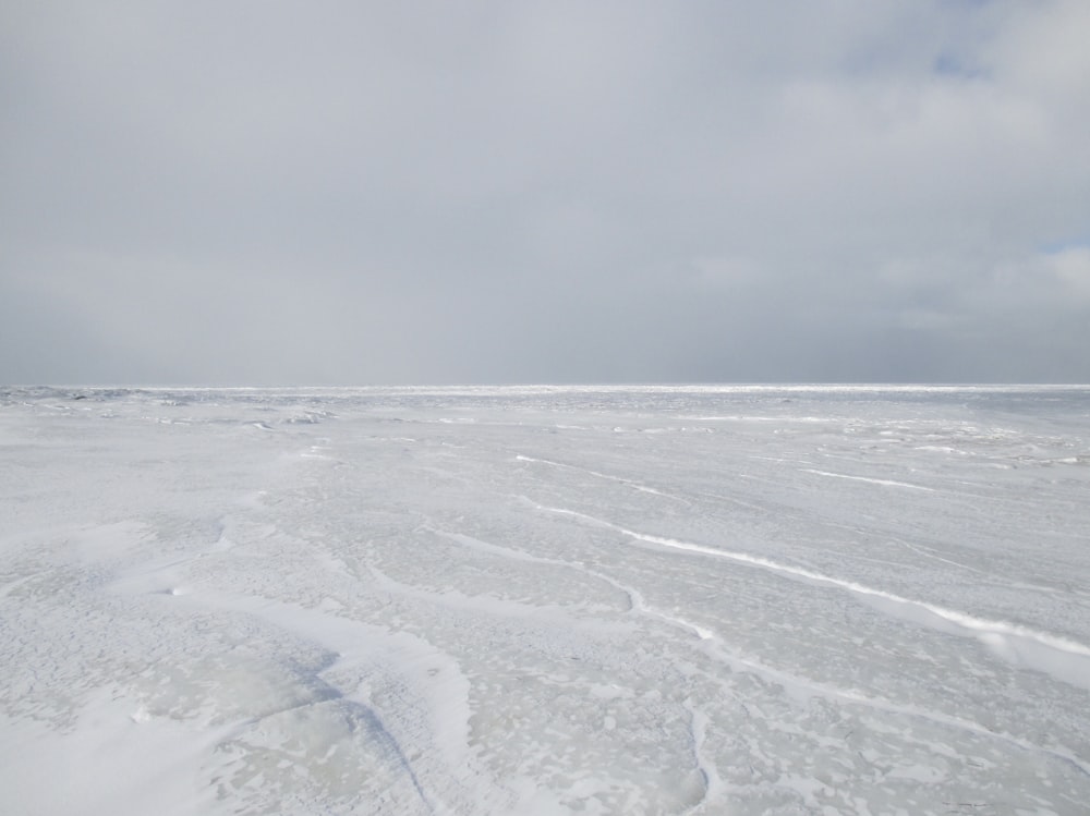 body of water under white clouds