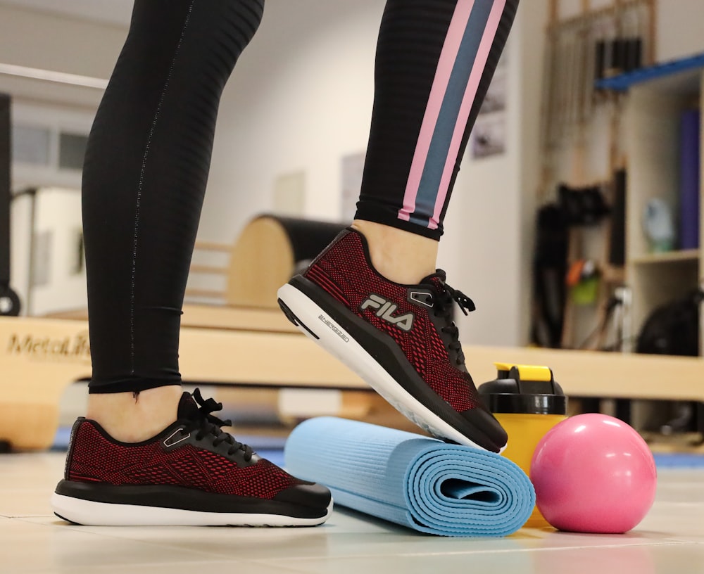 person standing beside yoga mat