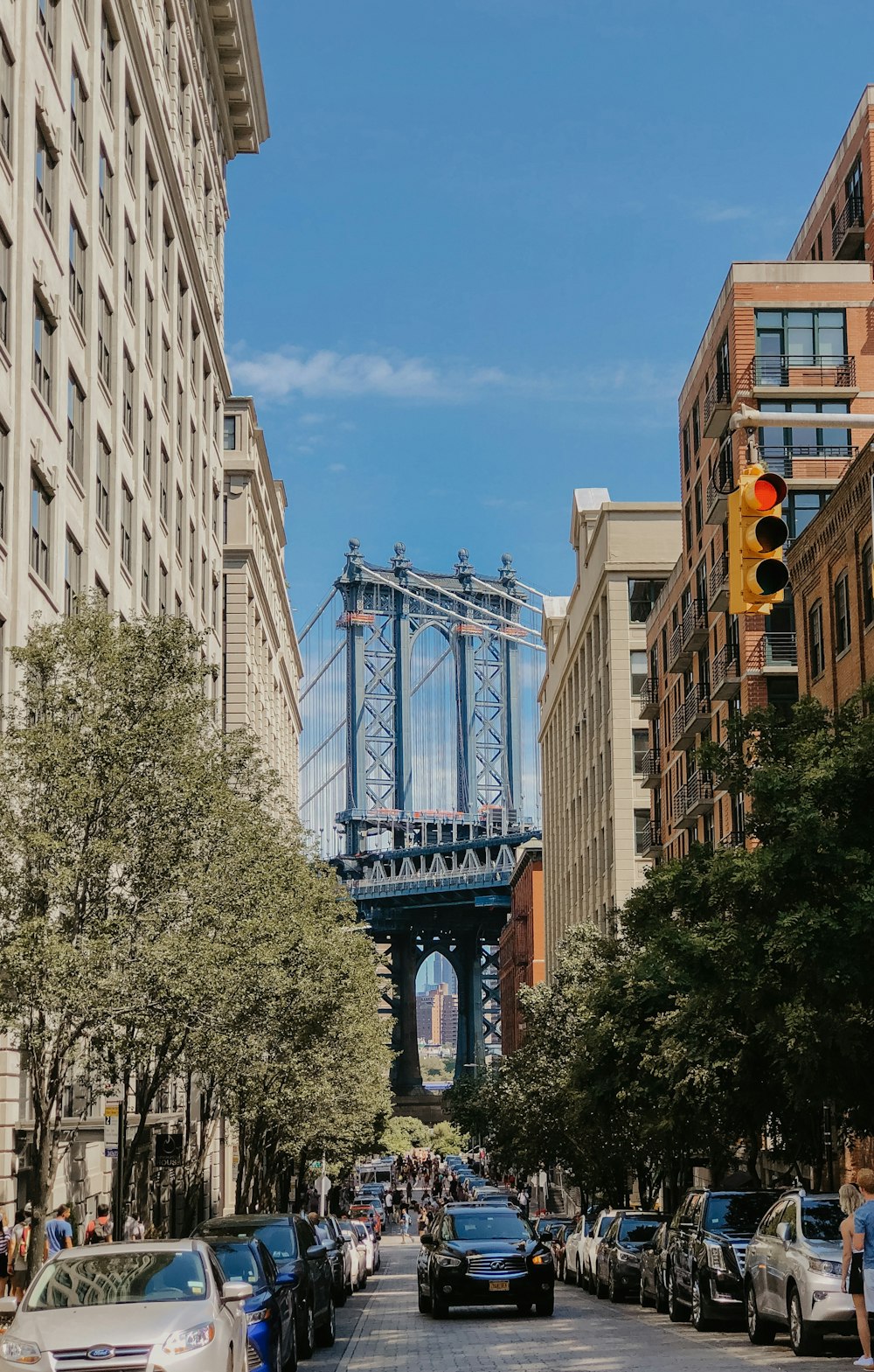 a traffic light on a city street with a bridge in the background