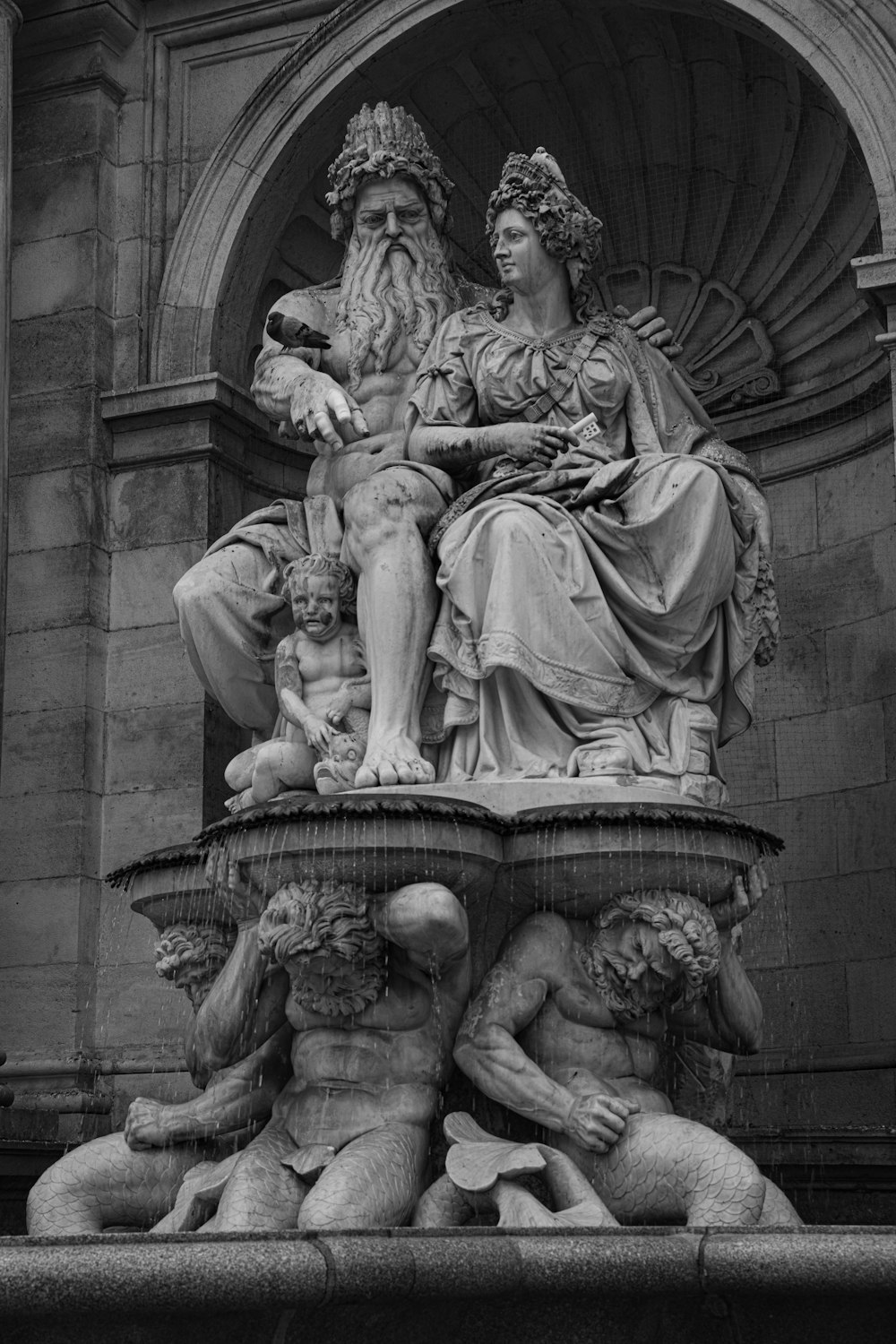 greyscale photo of medieval statues
