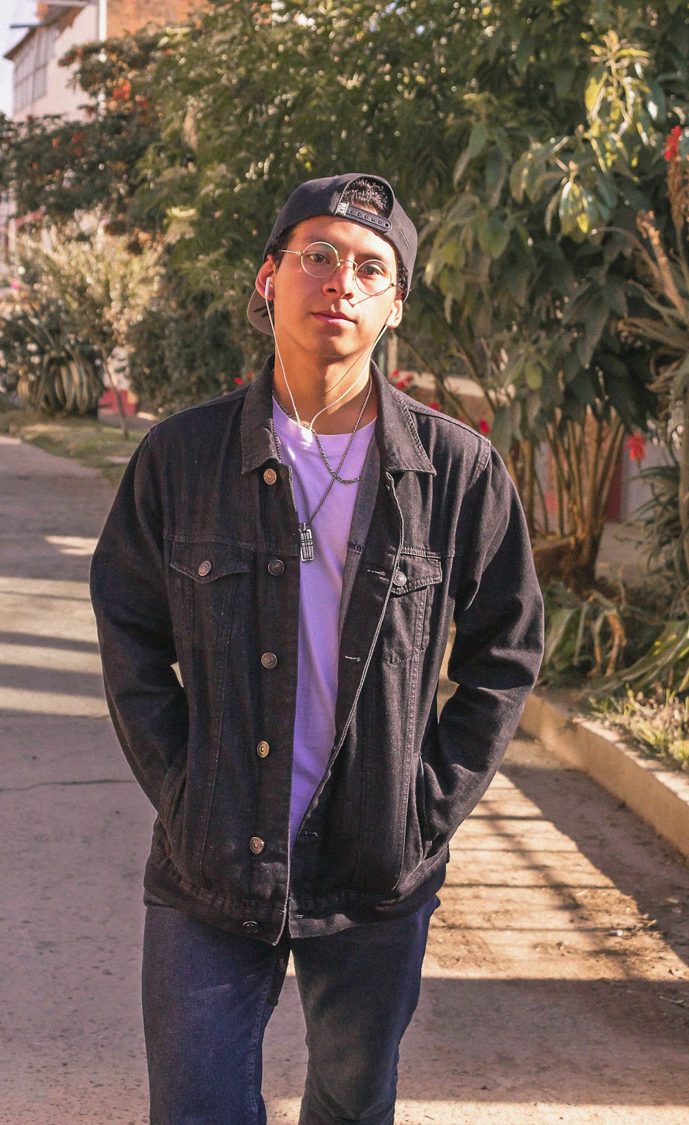 man in snapback cap and black button-up jacket