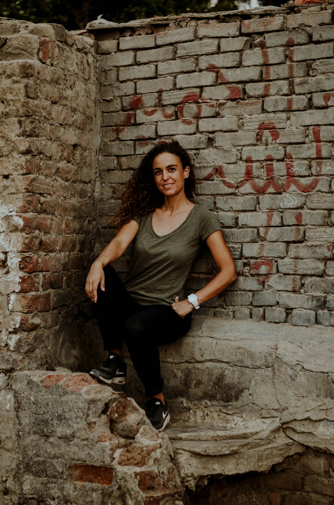 woman leaning beside wall