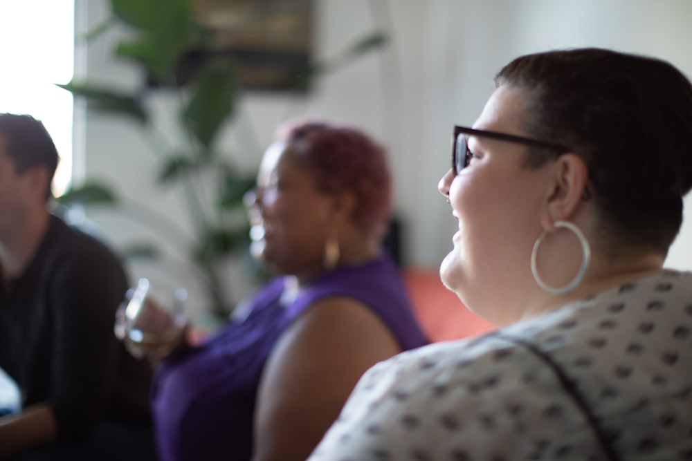 woman in white shirt beside woman in purple tank top