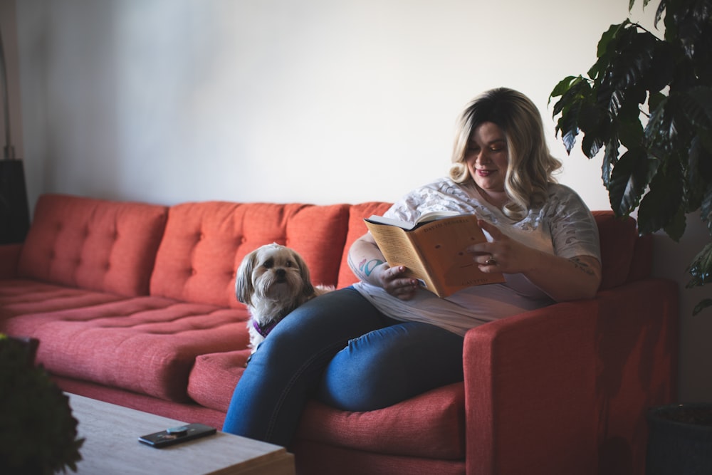 woman sitting on red sofa