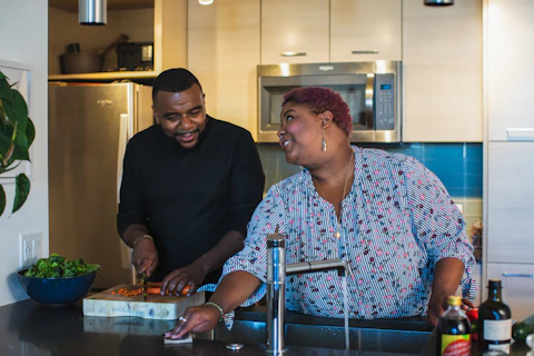 man and woman standing in front of sink