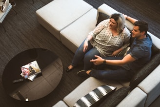A friendly consultant chatting with a homeowner in a cozy living room.