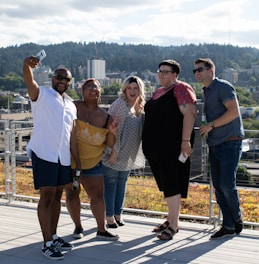 A warm photo of the Journaes team smiling together outdoors with city streets in the background.
