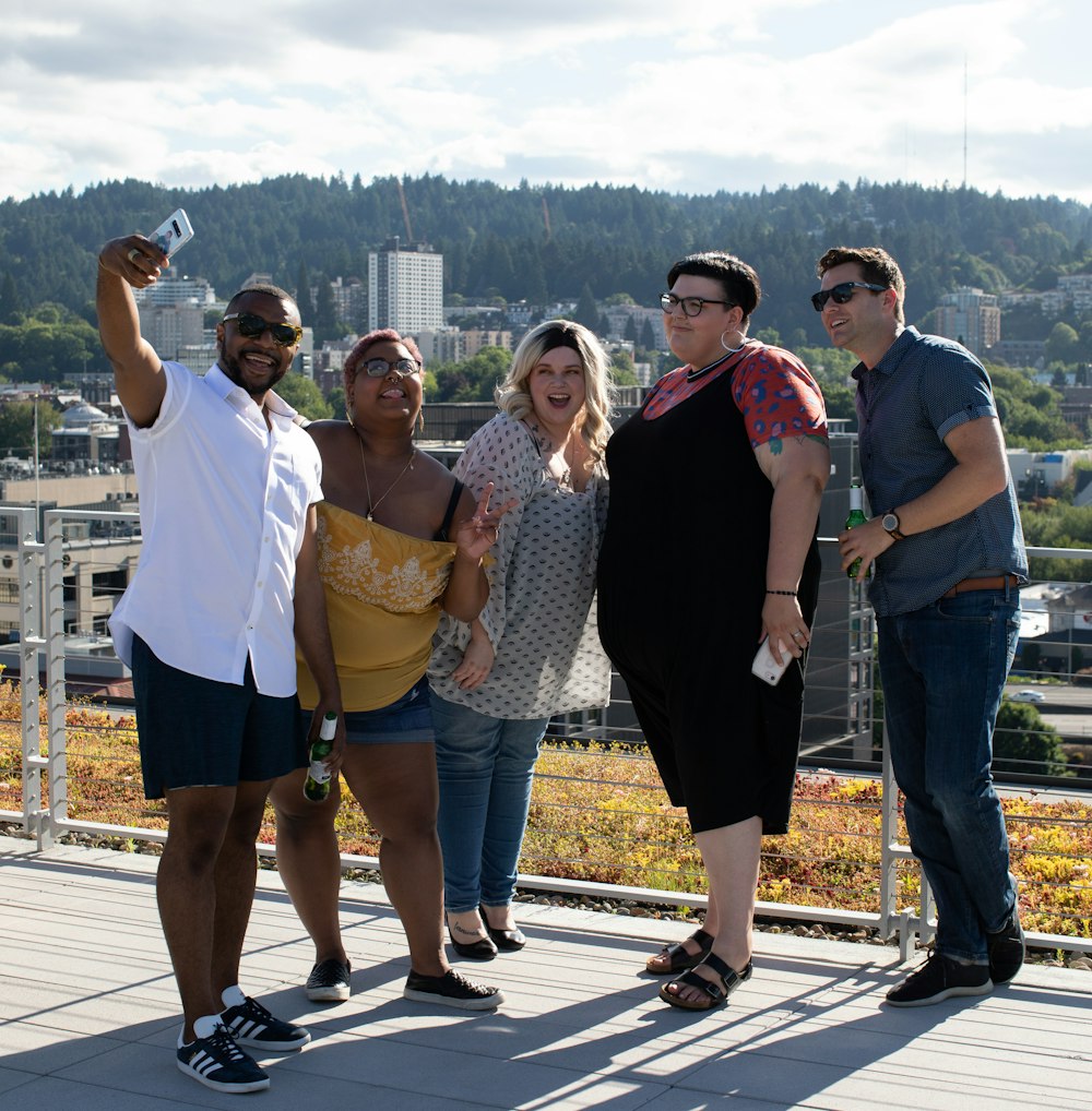 five people standing near railings