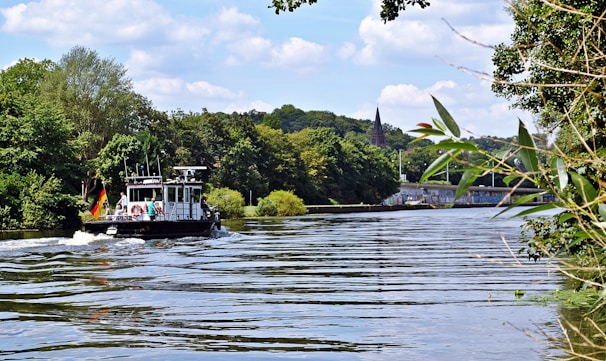 A serene view of the German Channel waters with a local elder sharing stories to a small group of tourists.
