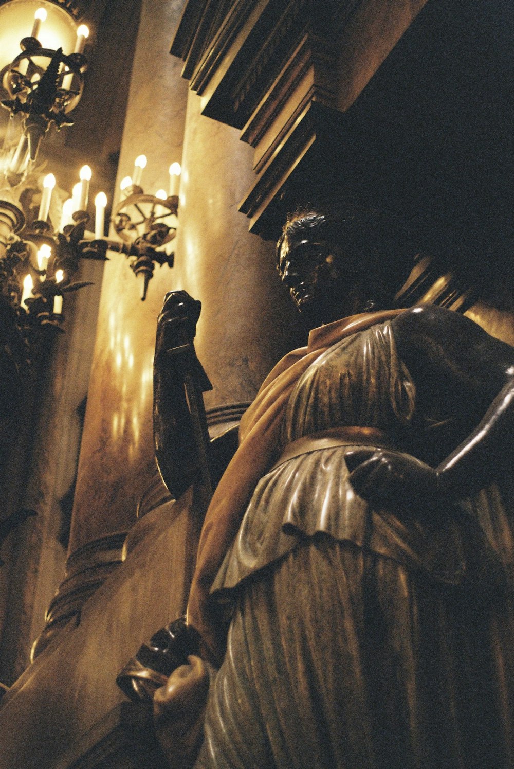 woman standing statue near lighted chandelier