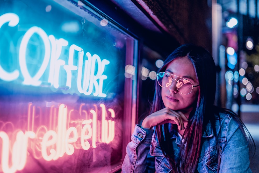 woman near lighted signage