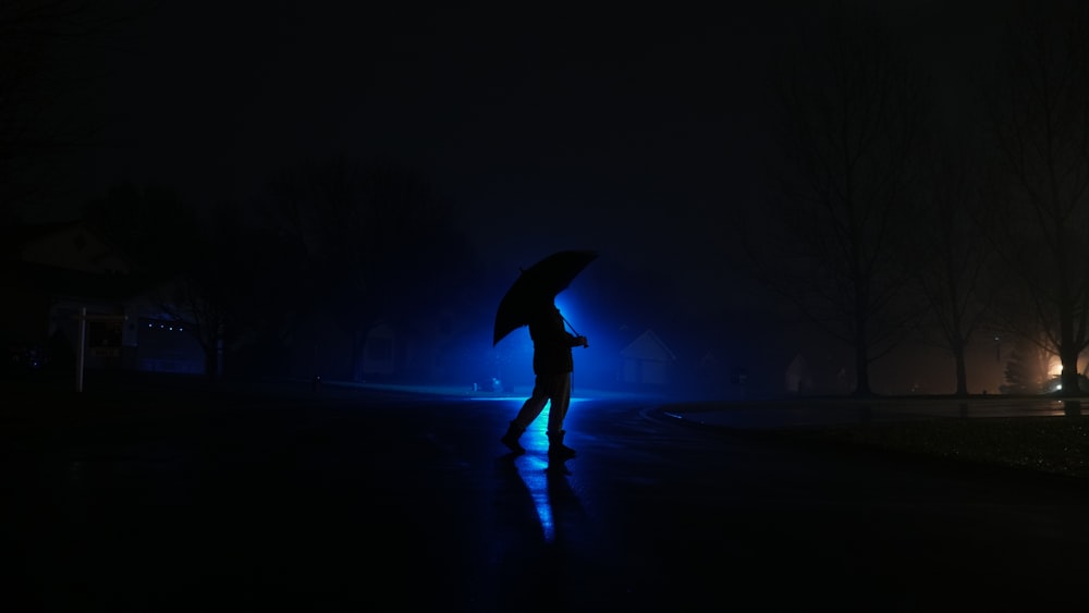 person standing while using umbrella