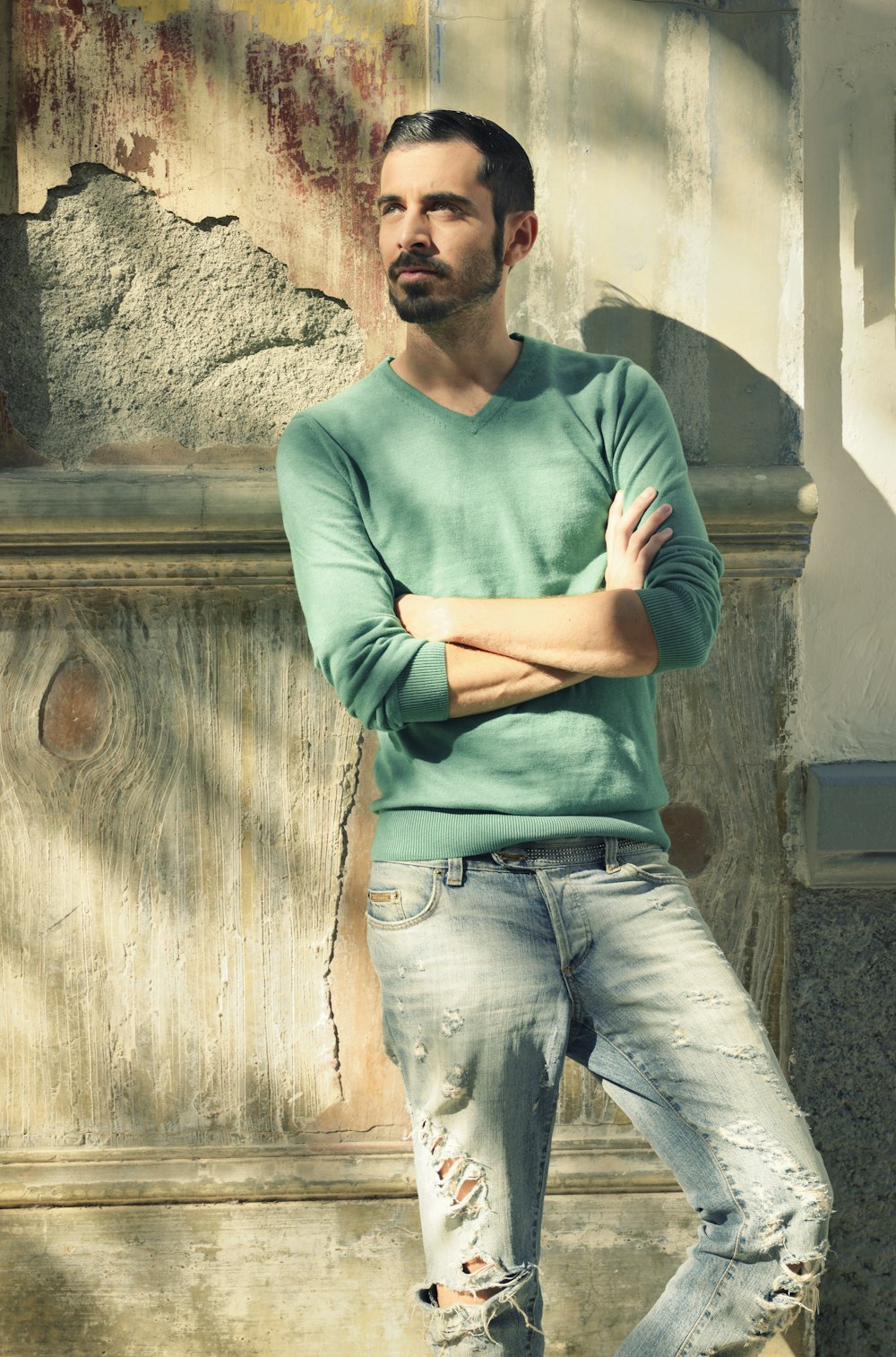 man leaning on wall