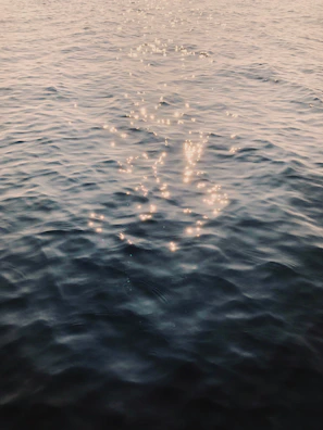 Delicate star-shaped light reflections twinkling over a smooth midnight blue surface