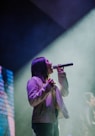 girl holding microphone close-up photography