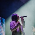 girl holding microphone close-up photography