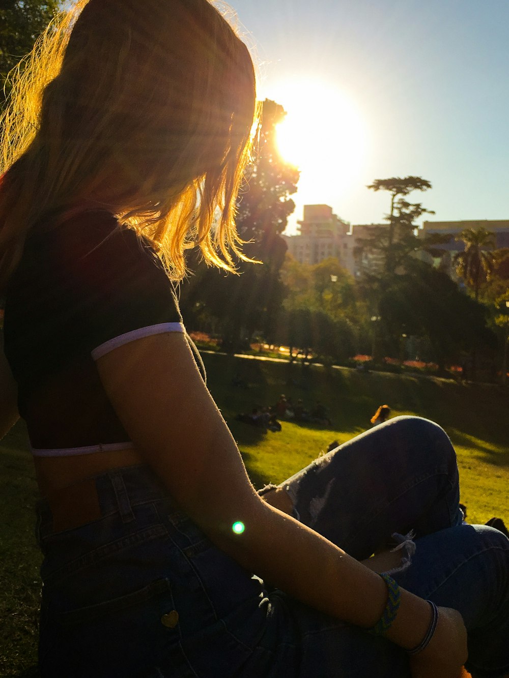 woman wearing black and white crop top and distressed blue denim jeans during daytime