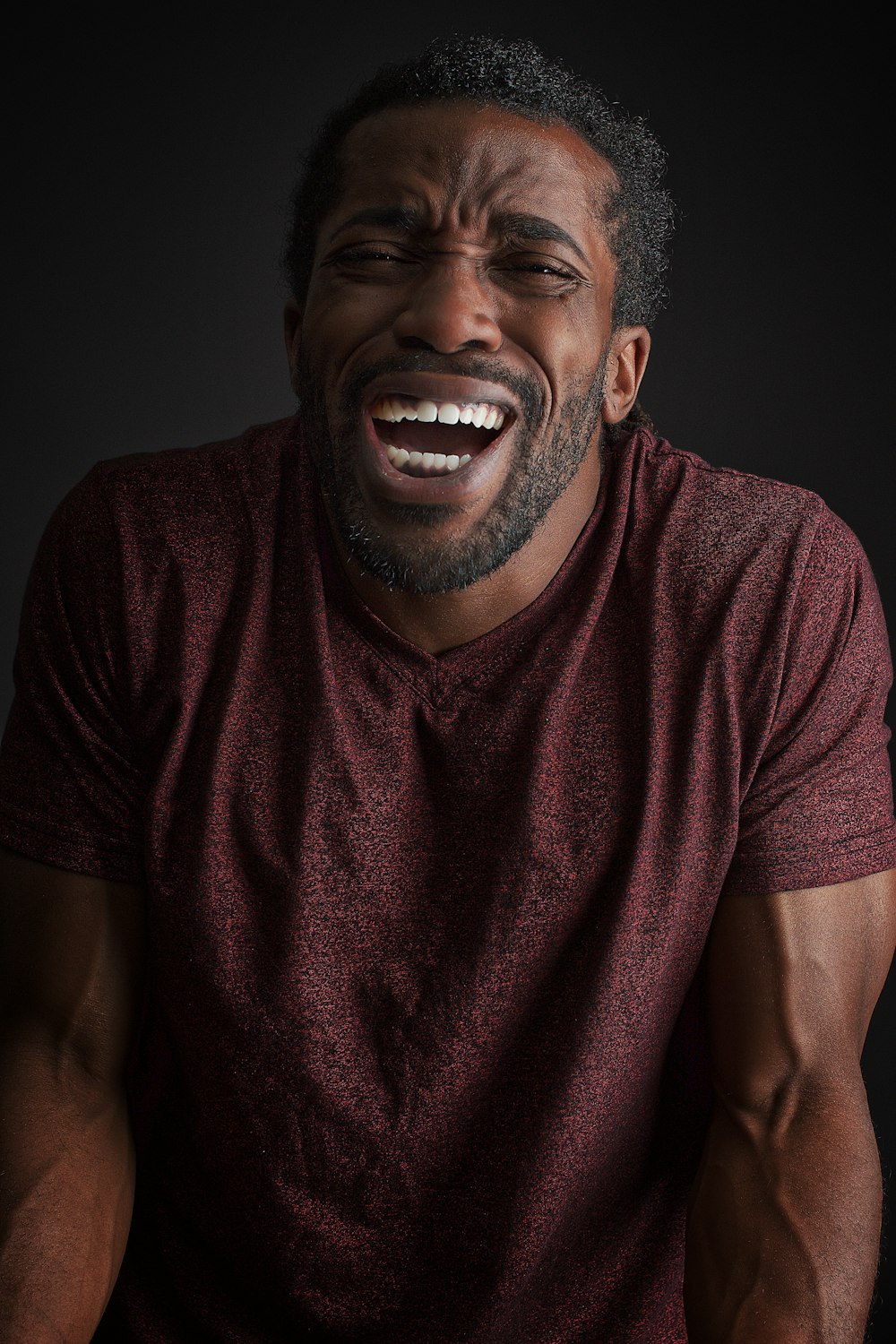 smiling man wearing brown t-shirt