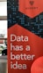 A promotional banner with a bold red background features the text 'Data has a better idea' in large white letters. Above the text, the word 'HIVERY' is printed along with a stylized logo resembling a beehive. The background also includes a pattern of blue circles and dots, giving a digital or technological feel. In the surrounding area, there's a partial view of a desk and some office supplies.