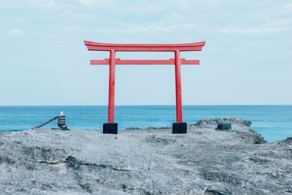 red tori on rocky surface fronting the sea