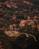 An aerial view of a military base nestled in rugged terrain.