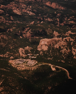 An aerial view of a military base nestled in rugged terrain.