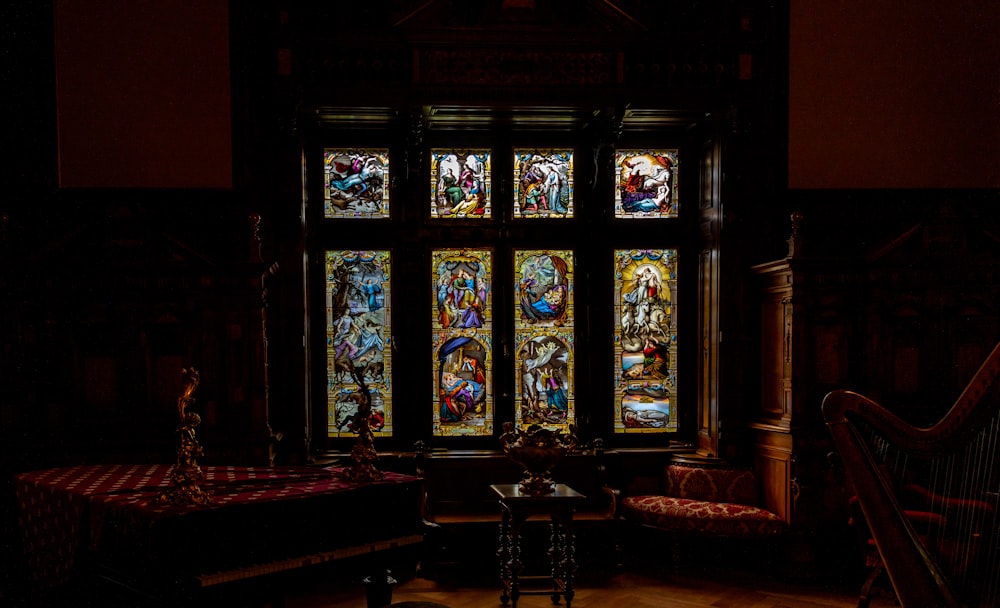 a large stained glass window in a dark room