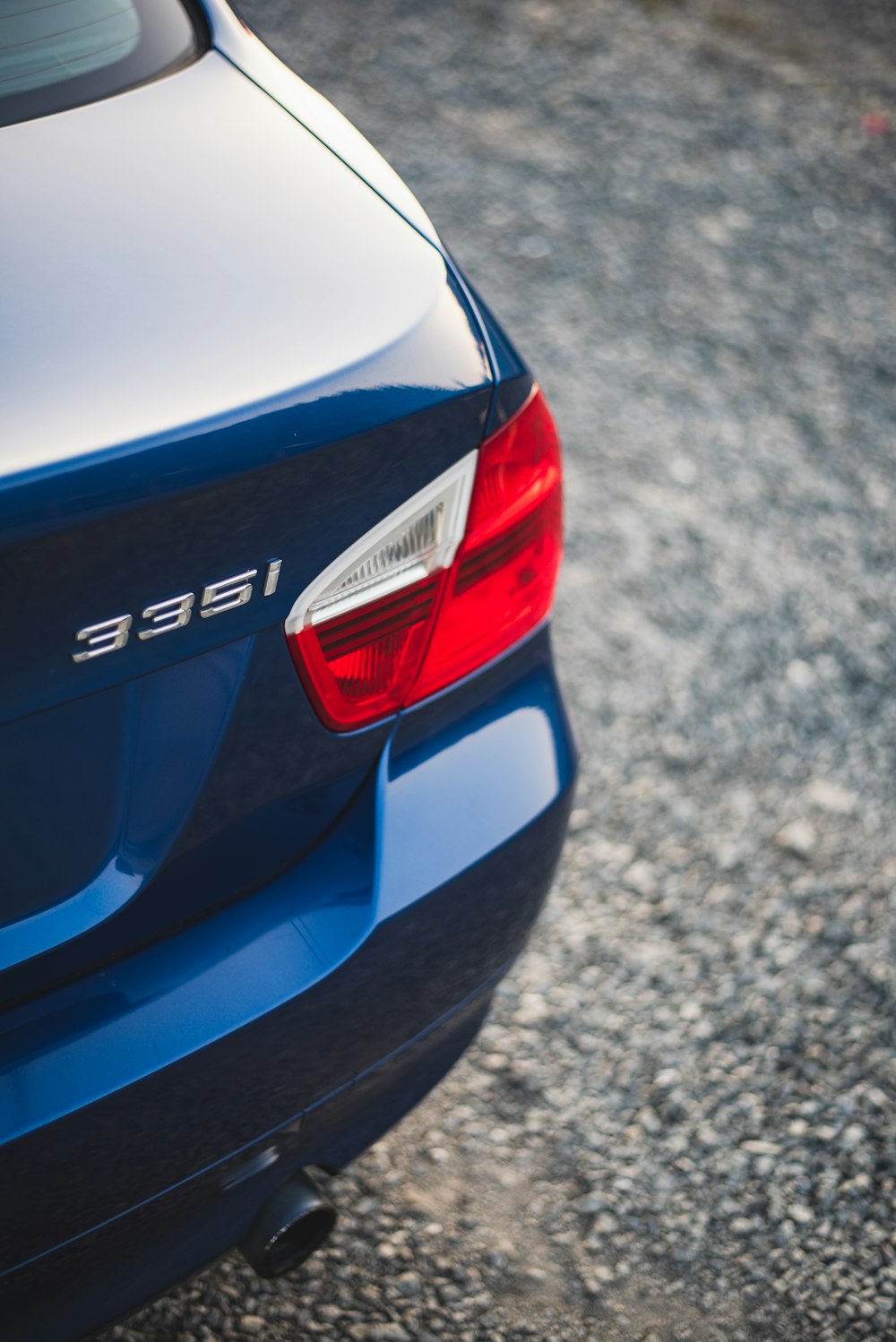 a close up of the tail end of a blue car