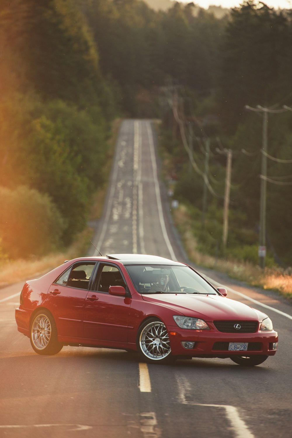 red Lexus sedan on road