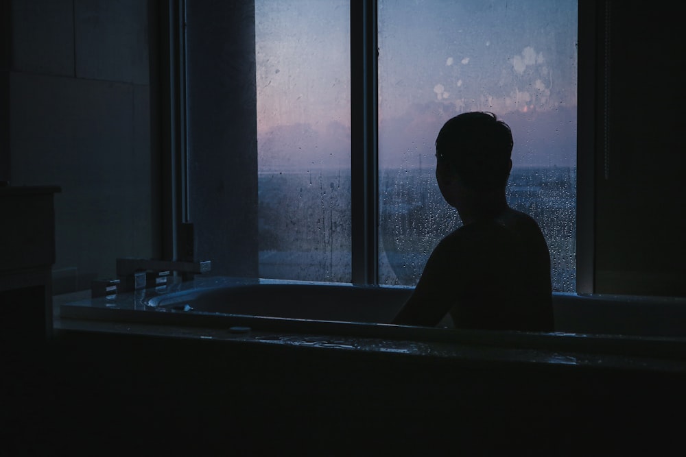 man sitting in bathtub