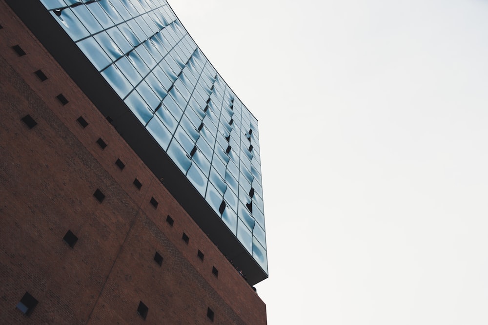 a tall brick building with a sky background