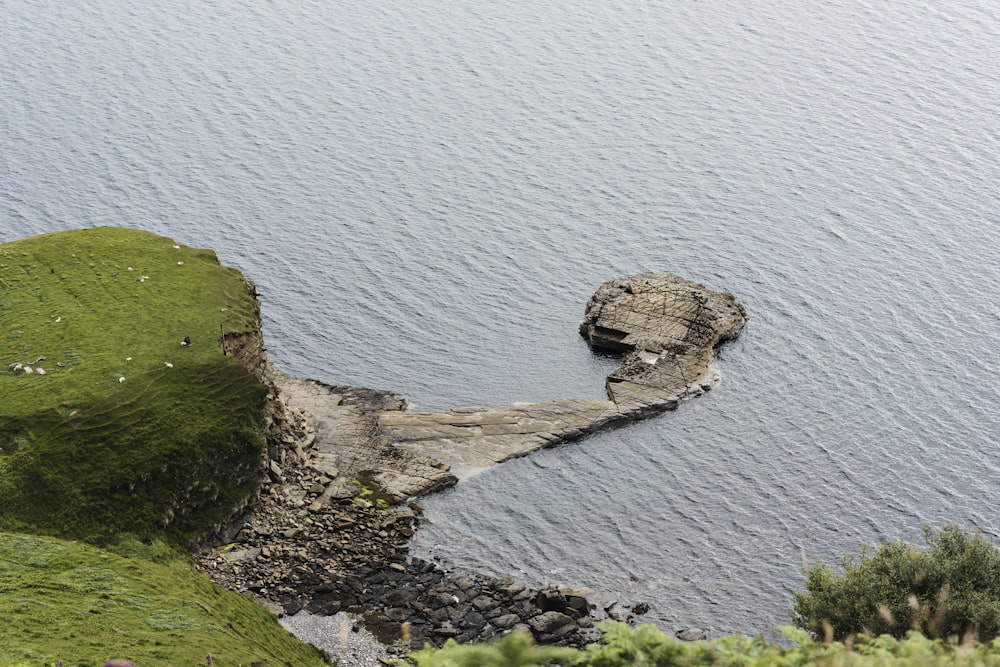 body of water with green hills