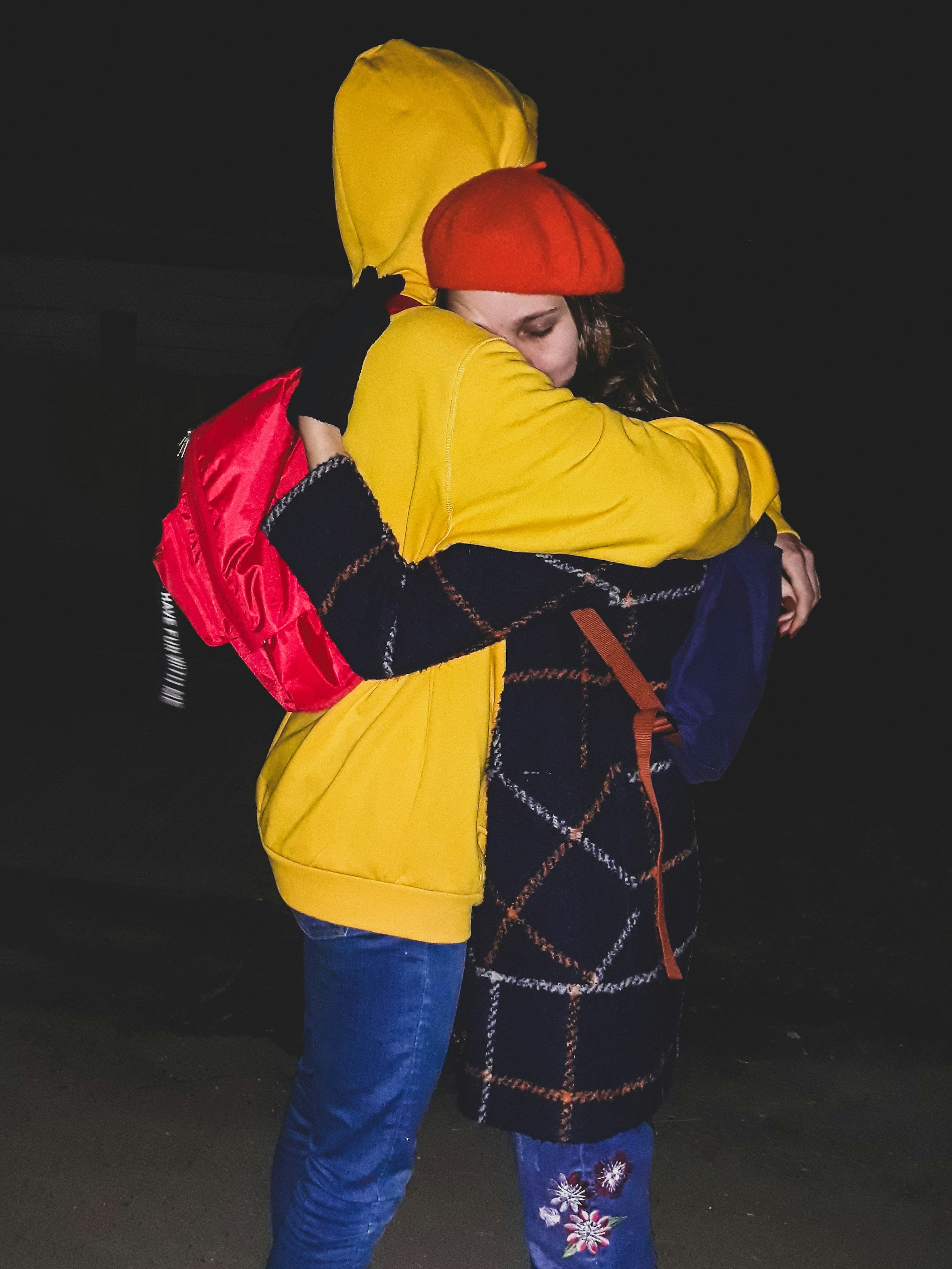 man and woman standing and hugging
