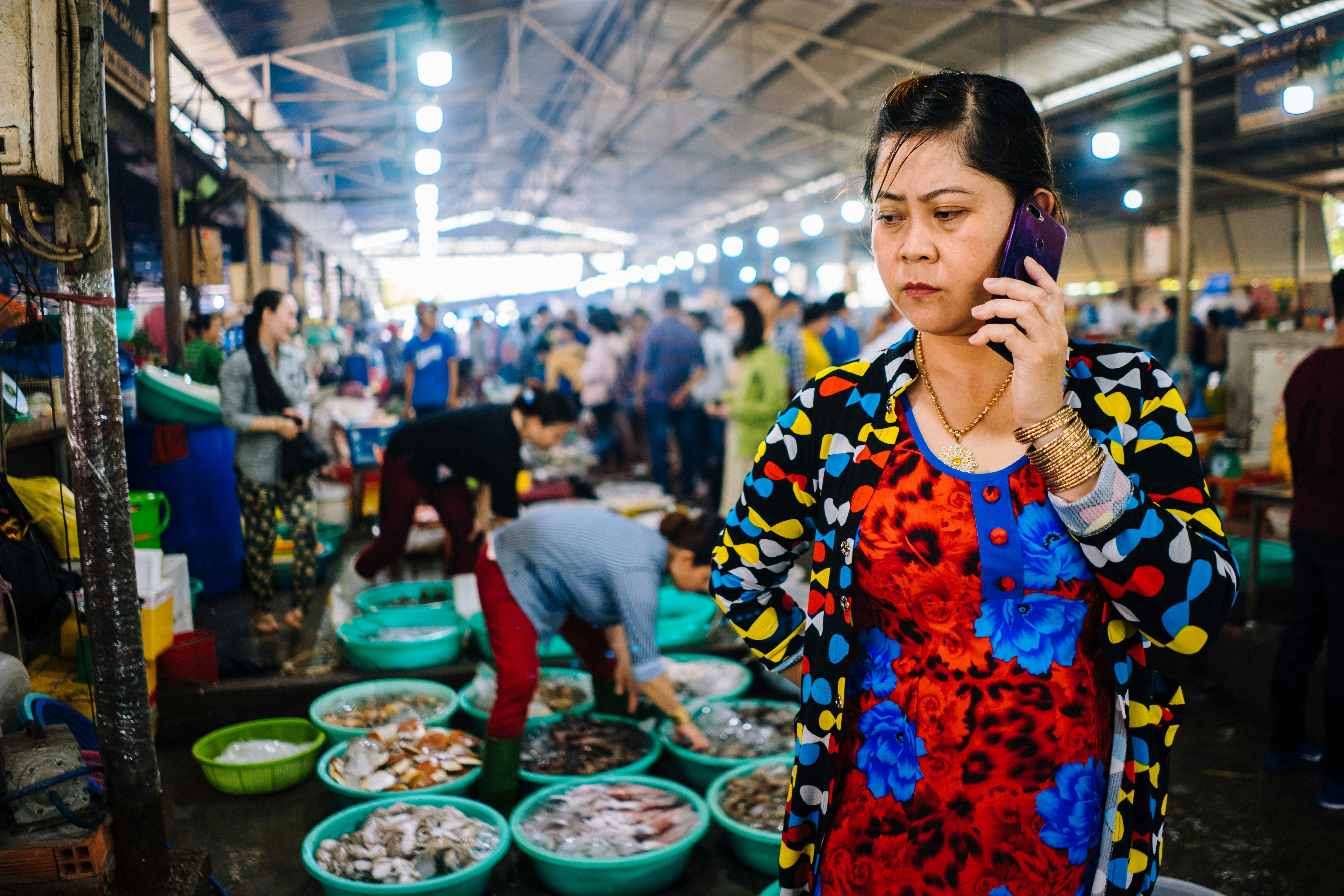 woman holding Android smartphone