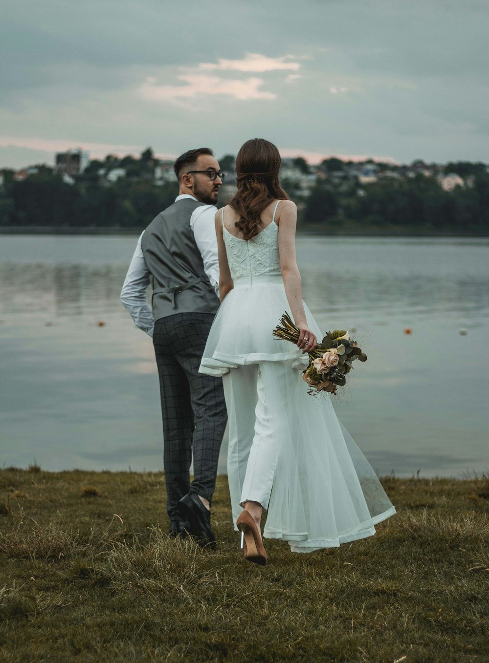 woman and man standing on grass field