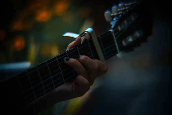 a close up of a person playing a guitar