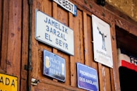 A collection of custom laser-cut signs displayed on a wall.