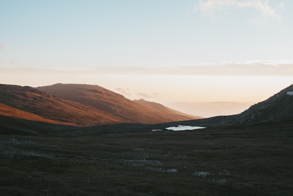 green grassland across brown mountain