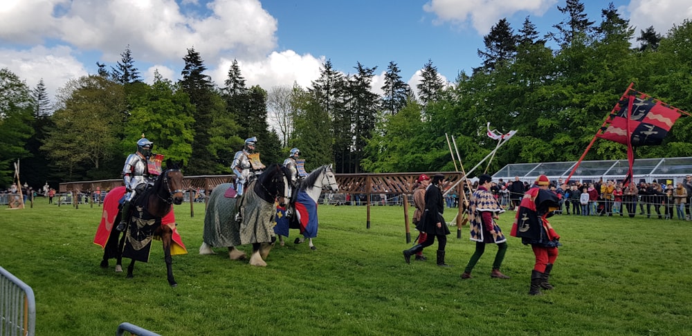 three knights riding on horses