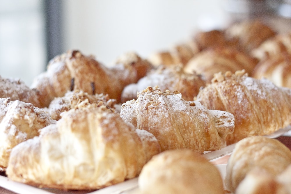 a bunch of croissants that are sitting on a table