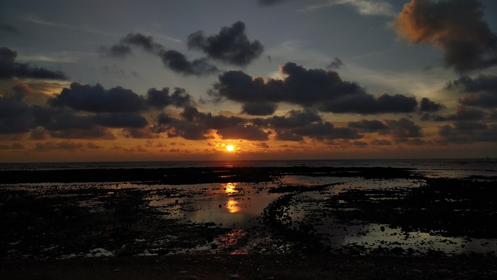 sun rise and body of water