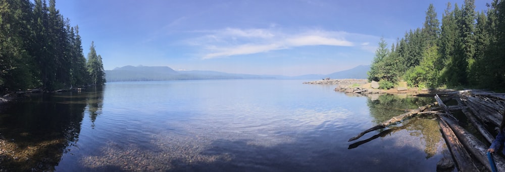 calm blue sea viewing mountain under blue and white skies