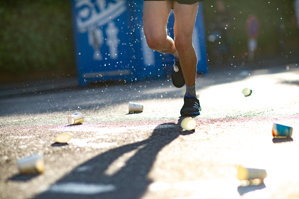 person standing on ground with lots of paper cups