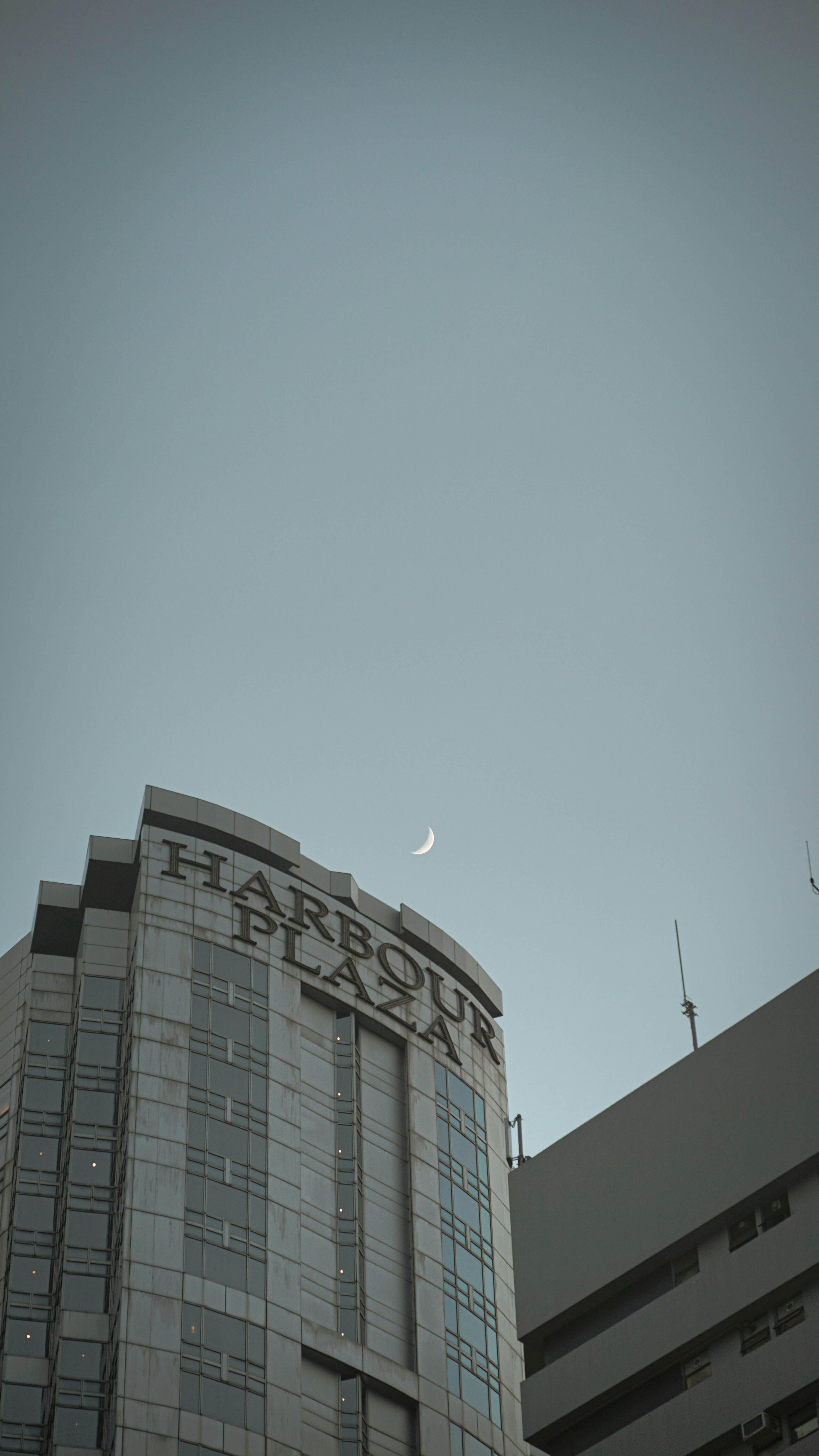 Moon crescent hanging over the Harbour Plaza