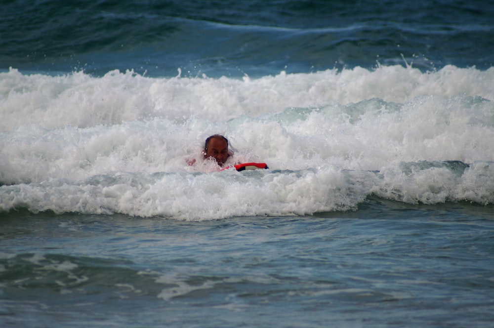 man swimming in sea