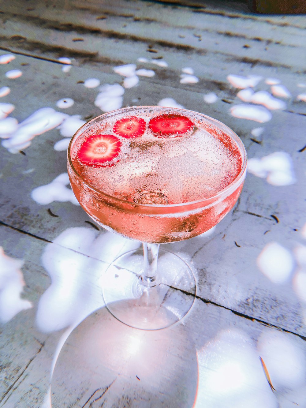 filled footed glass with strawberry drink