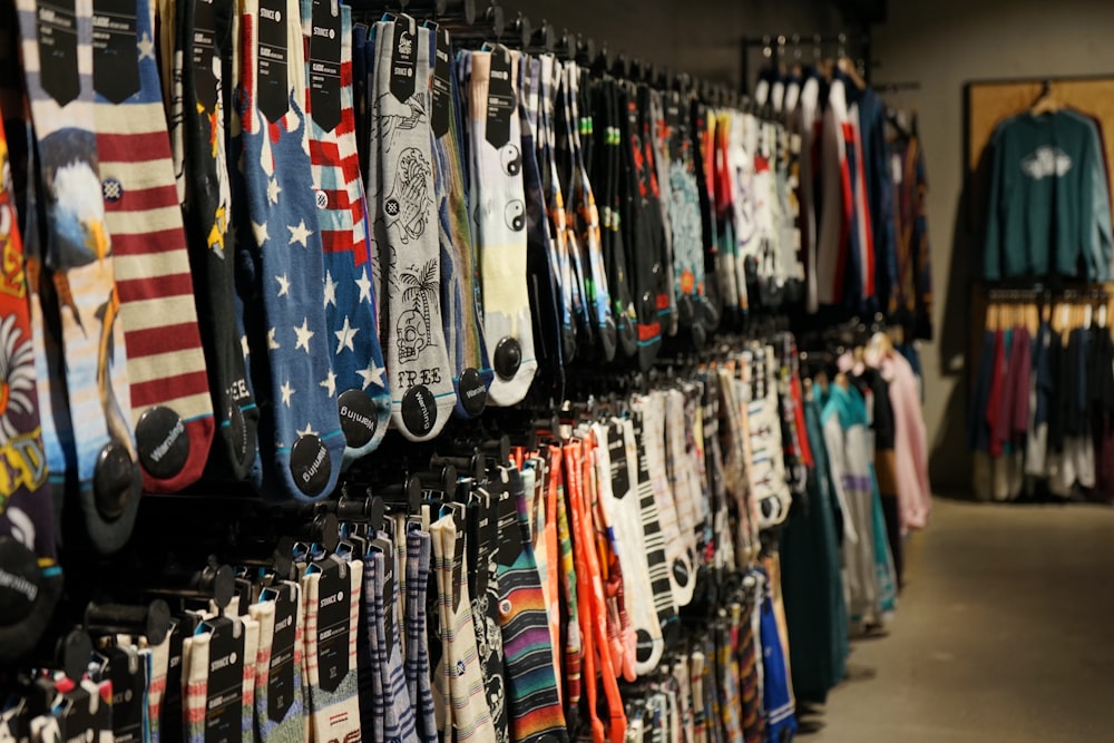 assorted clothes hung on display racks